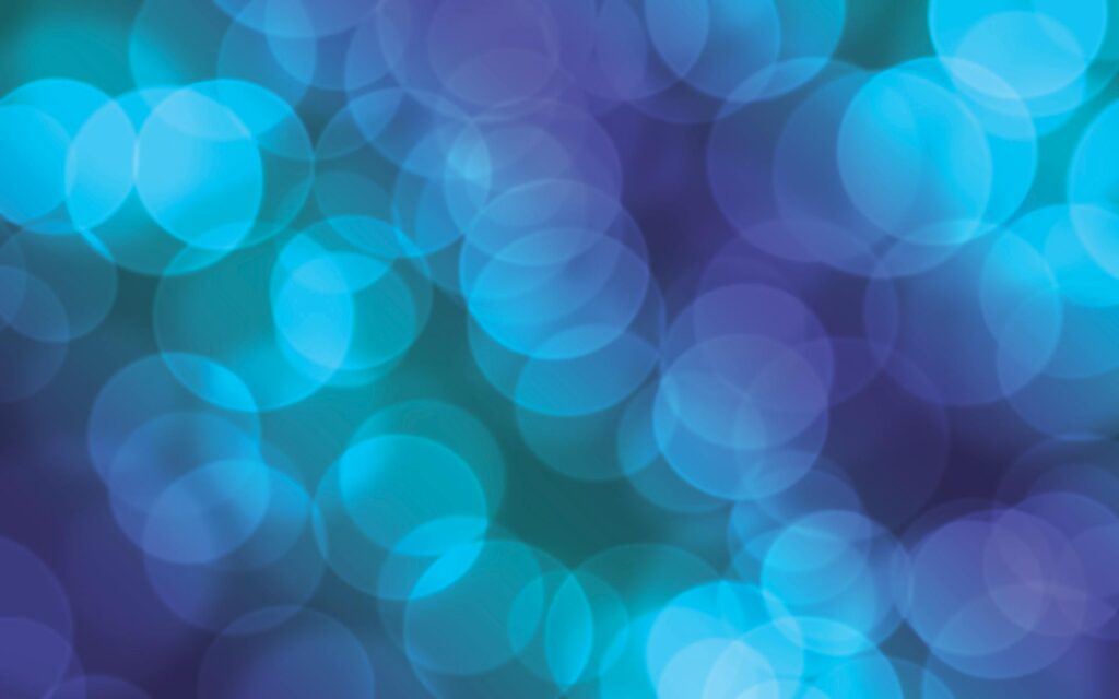A vivid abstract bokeh background with blue and purple lights, perfect for design use.